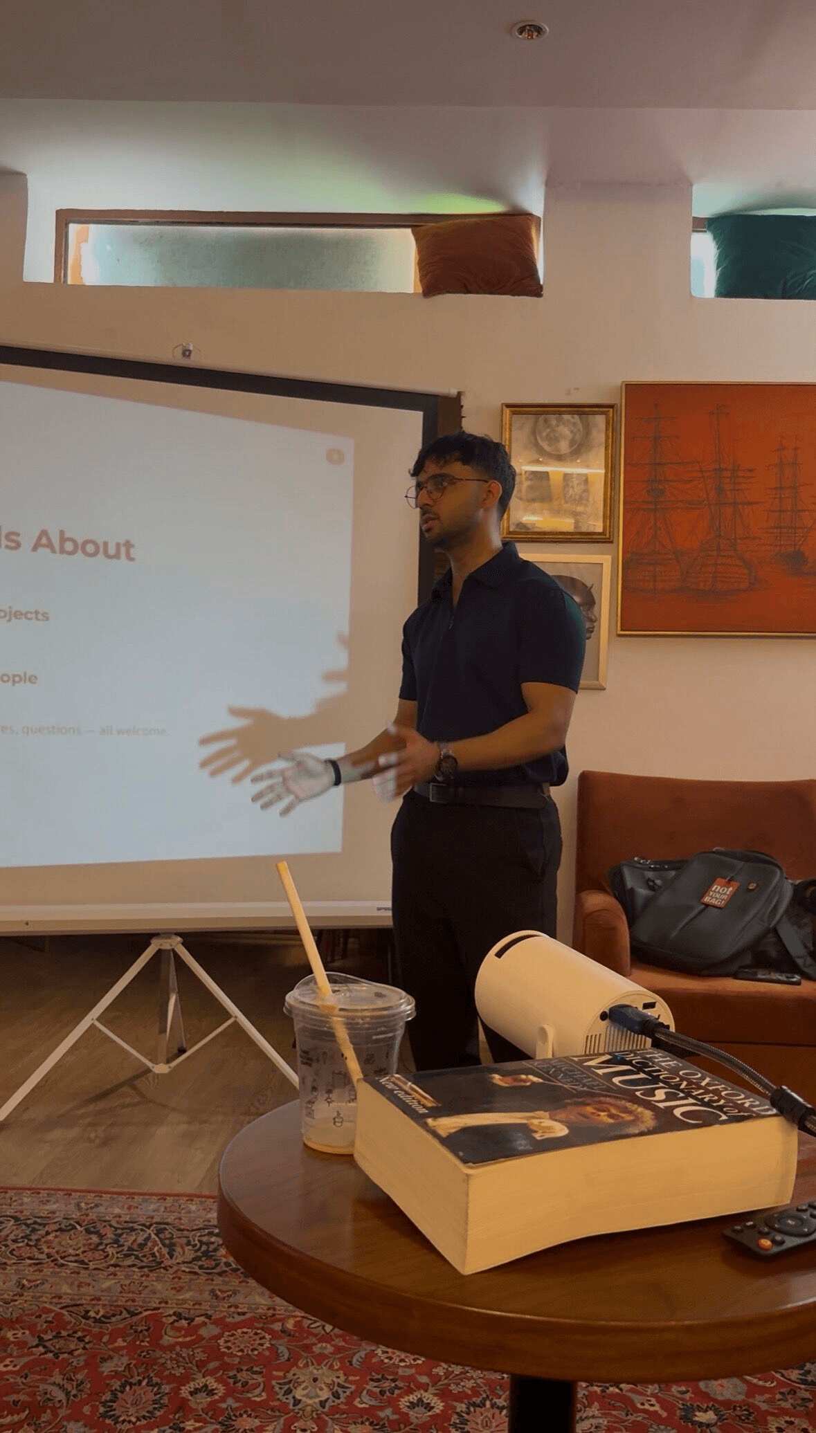 Haseeb Zaheer presenting beside a projection screen